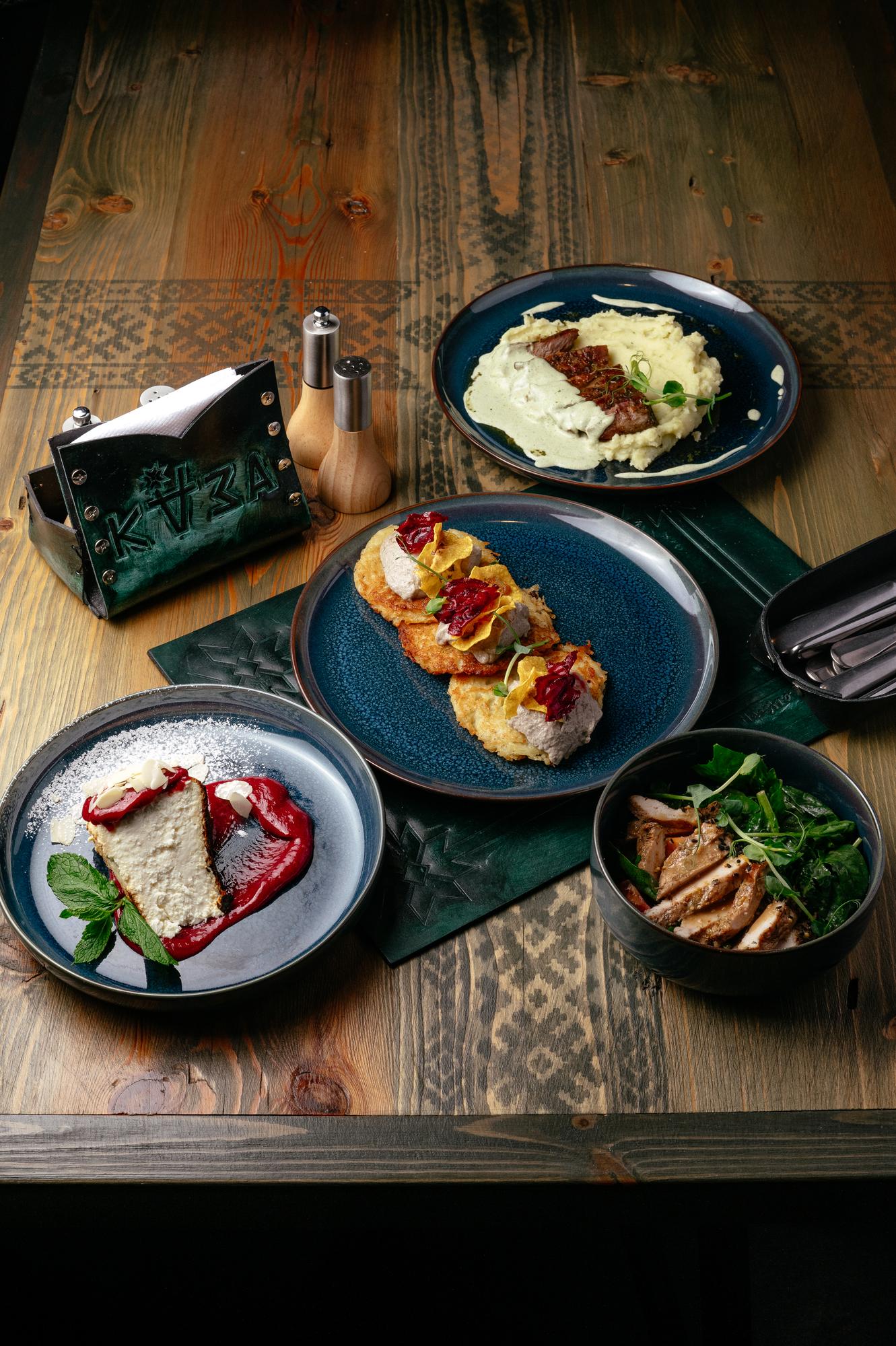 set of plated tasting menu on wooden table